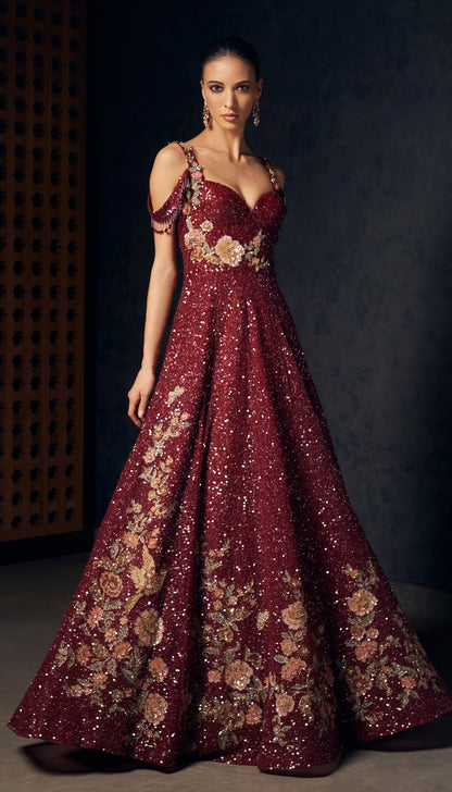 A ruby wine tulle gown with tone on tone sequins and delicate floral embroidery.