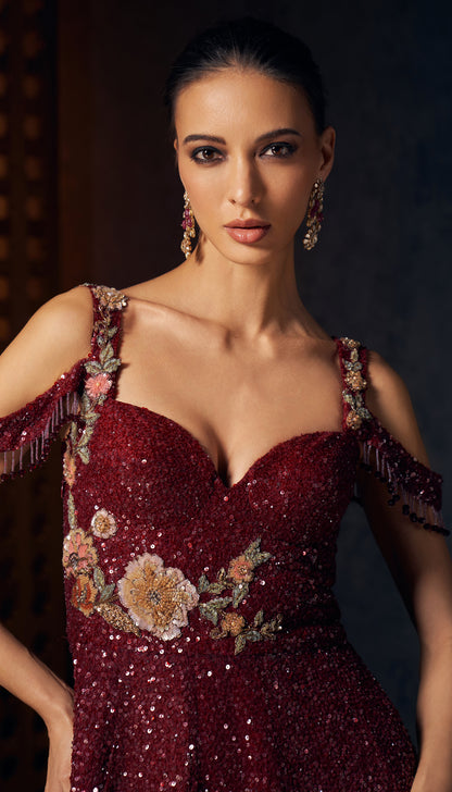 A ruby wine tulle gown with tone on tone sequins and delicate floral embroidery.