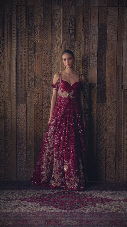 A ruby wine tulle gown with tone on tone sequins and delicate floral embroidery.